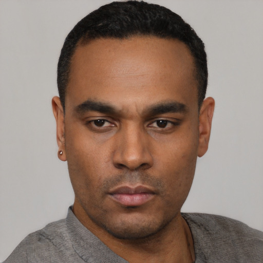 Neutral latino young-adult male with short  black hair and brown eyes