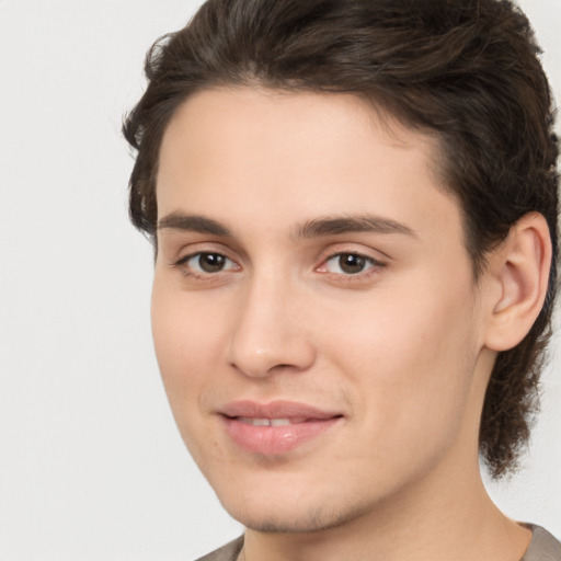 Joyful white young-adult male with medium  brown hair and brown eyes