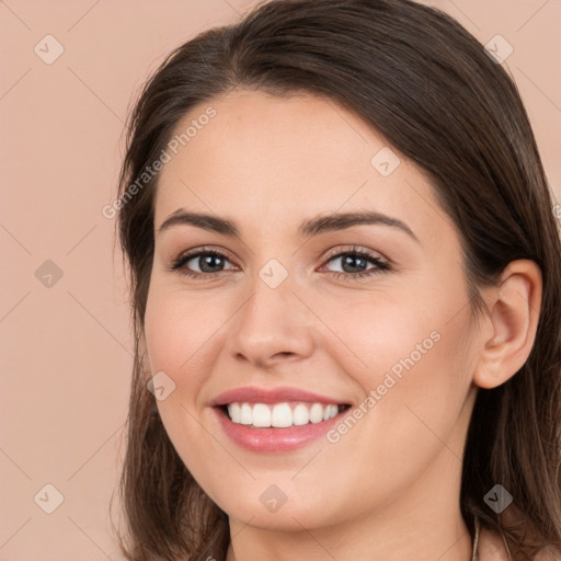 Joyful white young-adult female with long  brown hair and brown eyes