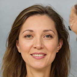 Joyful white adult female with long  brown hair and brown eyes