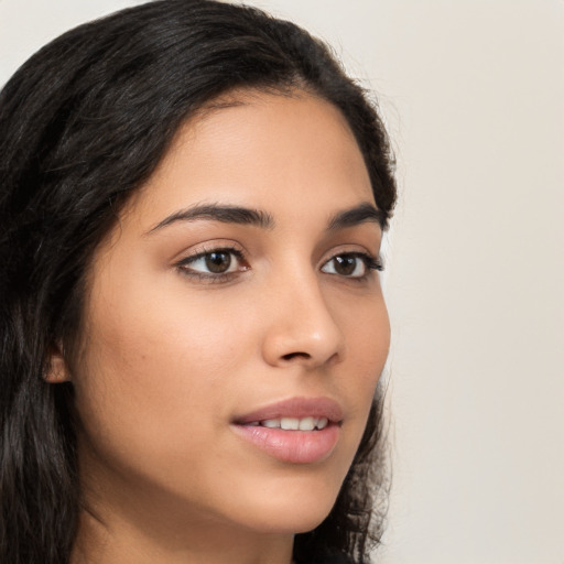 Joyful latino young-adult female with long  brown hair and brown eyes