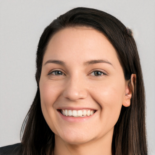 Joyful white young-adult female with long  black hair and brown eyes