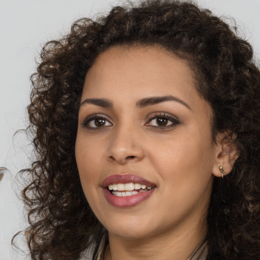 Joyful white young-adult female with long  brown hair and brown eyes