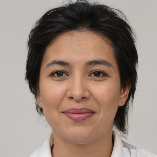 Joyful asian adult female with medium  brown hair and brown eyes