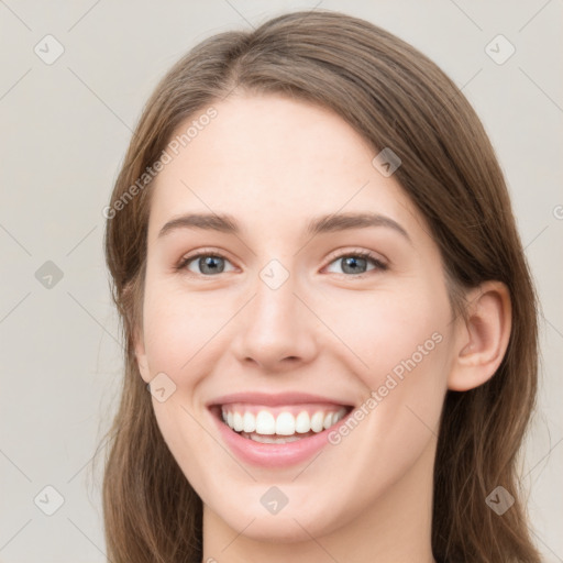 Joyful white young-adult female with long  brown hair and green eyes