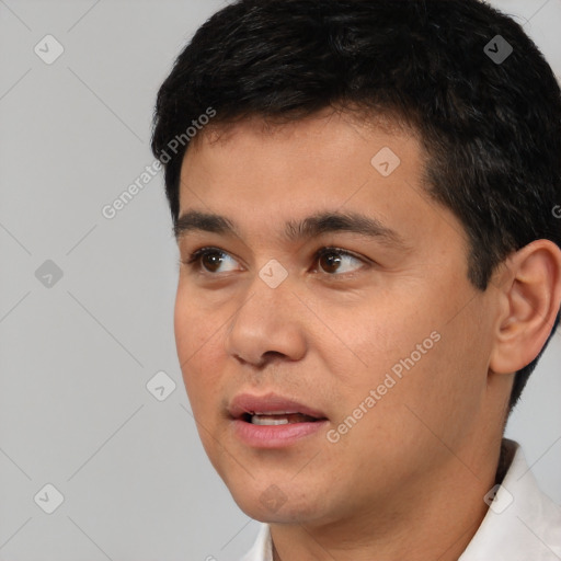 Joyful white young-adult male with short  black hair and brown eyes