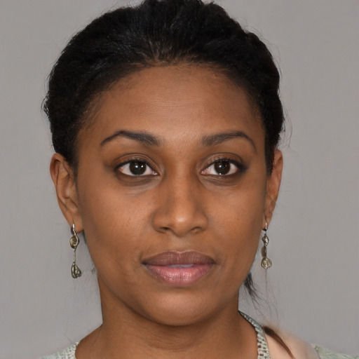 Joyful black young-adult female with medium  brown hair and brown eyes