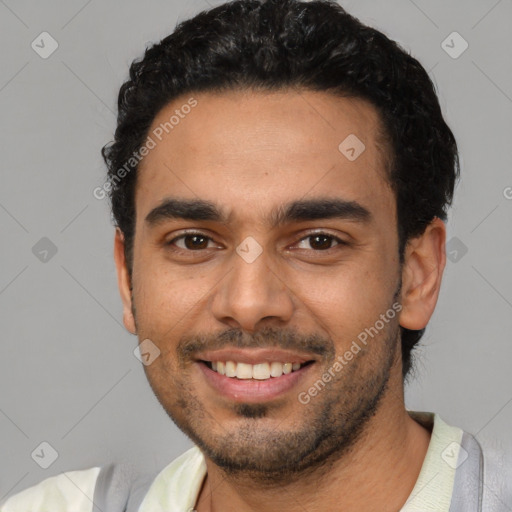 Joyful latino young-adult male with short  black hair and brown eyes