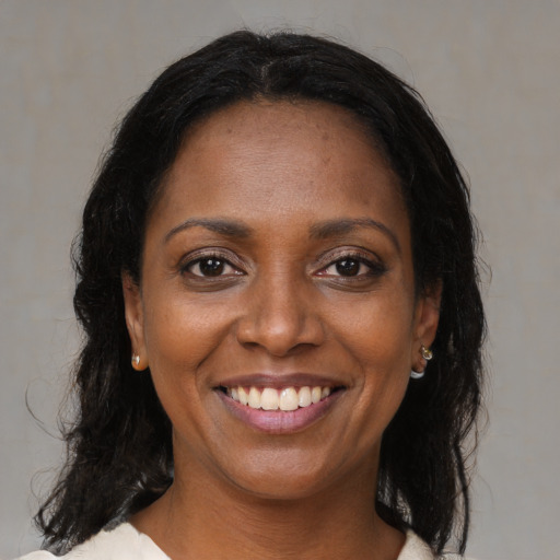 Joyful black young-adult female with medium  brown hair and brown eyes