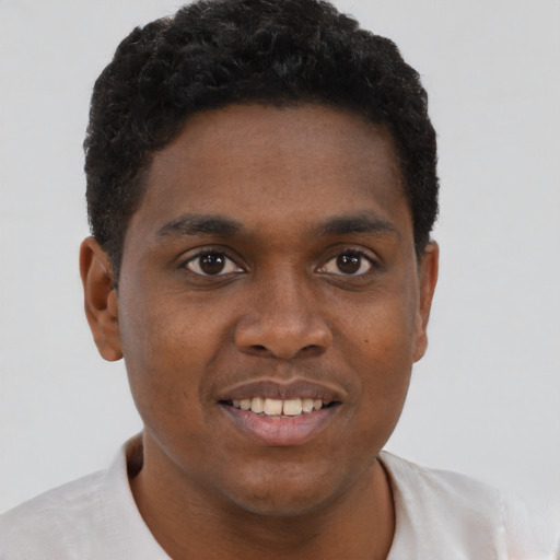 Joyful black young-adult male with short  brown hair and brown eyes