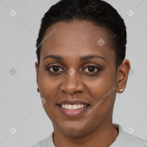 Joyful black young-adult female with short  black hair and brown eyes