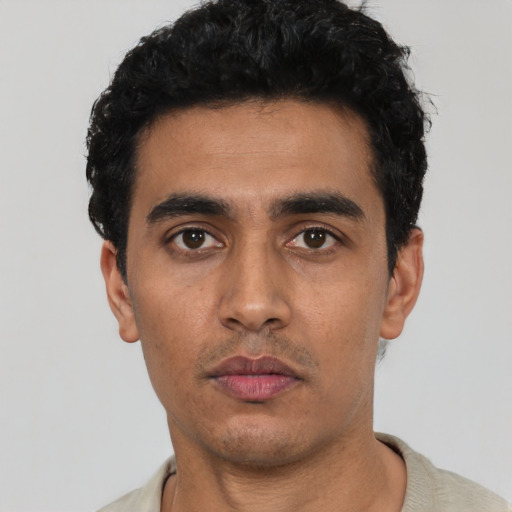 Neutral latino young-adult male with short  black hair and brown eyes