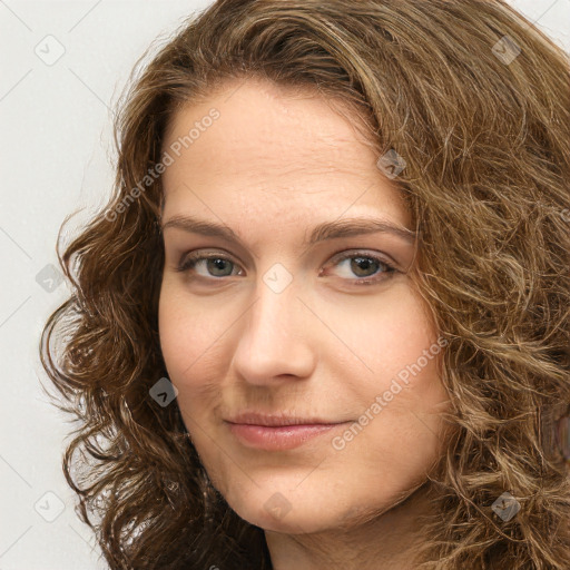 Joyful white young-adult female with long  brown hair and green eyes