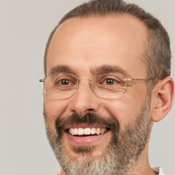 Joyful white adult male with short  brown hair and brown eyes