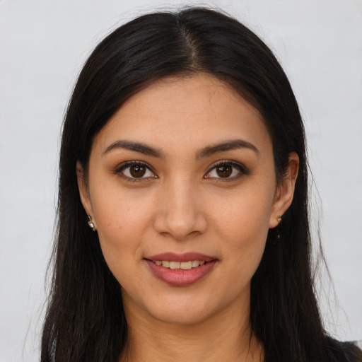 Joyful latino young-adult female with long  brown hair and brown eyes