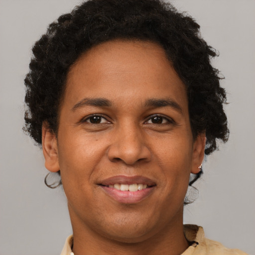 Joyful black adult female with short  brown hair and brown eyes