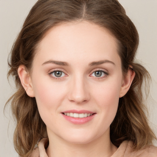 Joyful white young-adult female with medium  brown hair and blue eyes