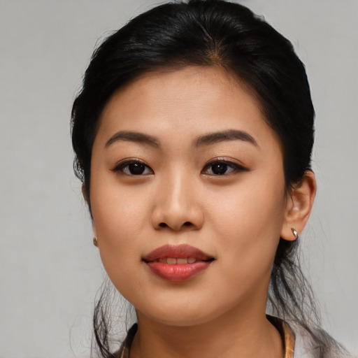 Joyful asian young-adult female with long  black hair and brown eyes