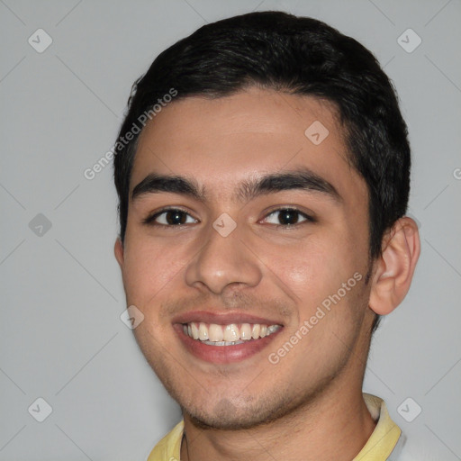 Joyful white young-adult male with short  black hair and brown eyes