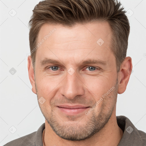 Joyful white adult male with short  brown hair and brown eyes