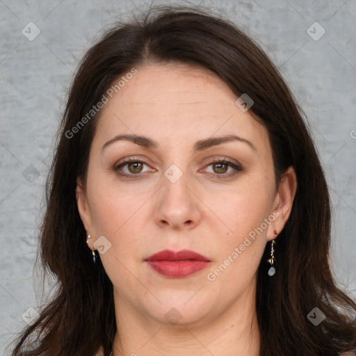 Joyful white adult female with long  brown hair and brown eyes