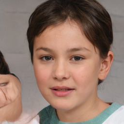 Joyful white child female with medium  brown hair and brown eyes