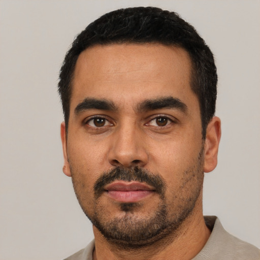 Neutral latino young-adult male with short  black hair and brown eyes