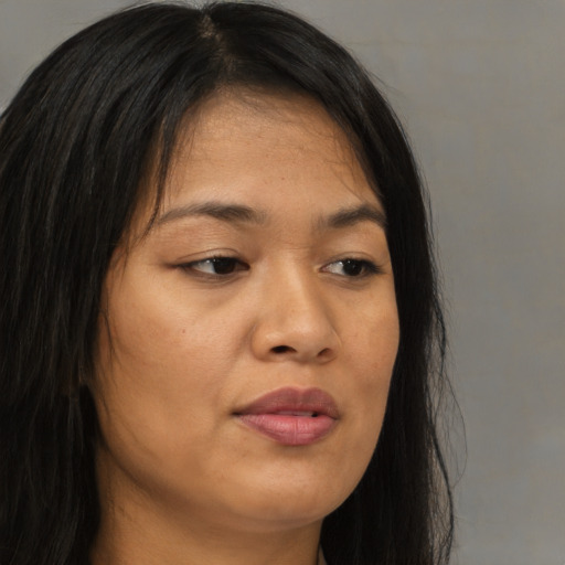 Joyful asian young-adult female with long  brown hair and brown eyes