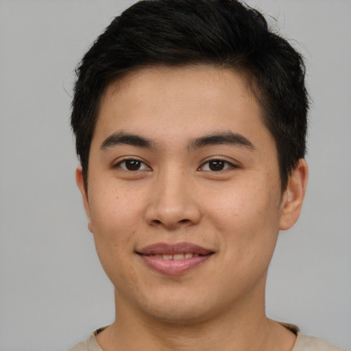 Joyful asian young-adult male with short  brown hair and brown eyes