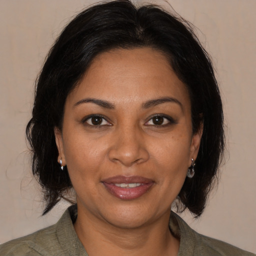 Joyful black adult female with medium  brown hair and brown eyes
