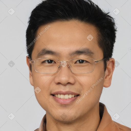 Joyful asian young-adult male with short  brown hair and brown eyes