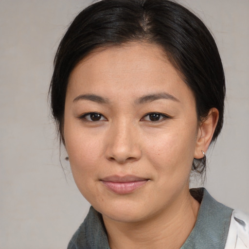 Joyful asian young-adult female with medium  brown hair and brown eyes
