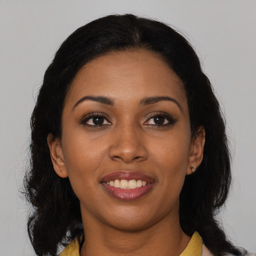 Joyful black young-adult female with medium  brown hair and brown eyes