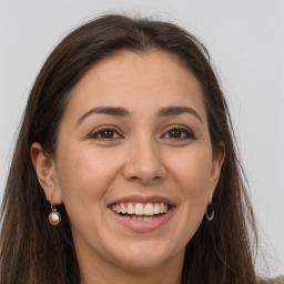 Joyful white young-adult female with long  brown hair and grey eyes