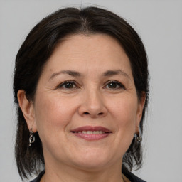 Joyful white adult female with medium  brown hair and grey eyes