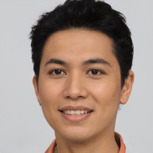 Joyful asian young-adult male with short  black hair and brown eyes