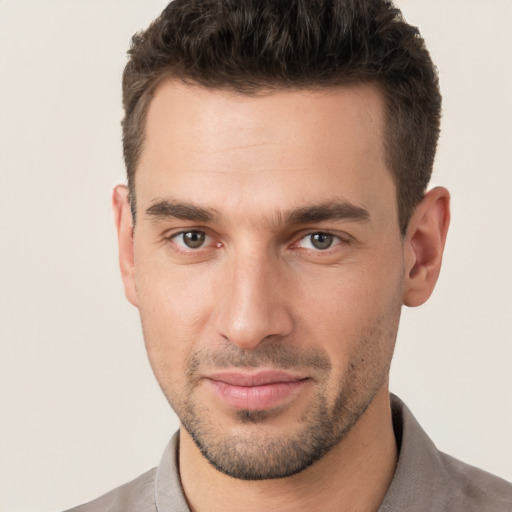 Joyful white young-adult male with short  brown hair and brown eyes