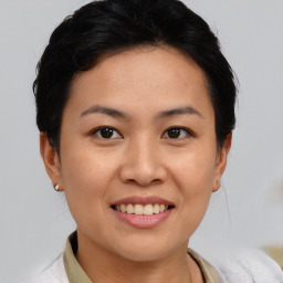 Joyful asian young-adult female with short  black hair and brown eyes