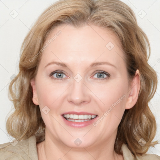 Joyful white adult female with medium  brown hair and blue eyes