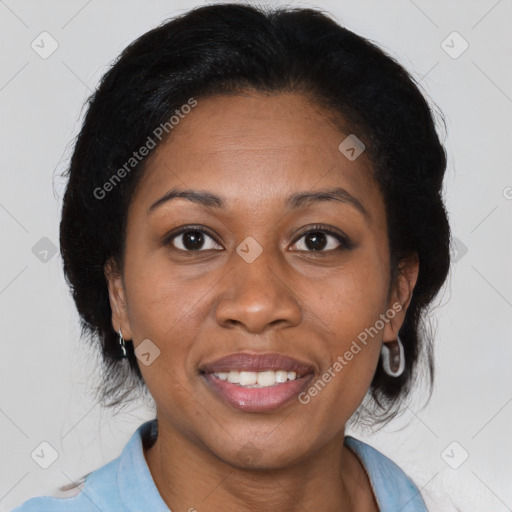 Joyful black adult female with medium  brown hair and brown eyes