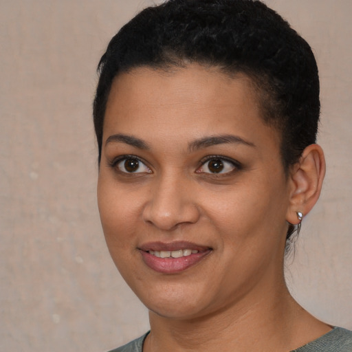 Joyful latino young-adult female with short  black hair and brown eyes