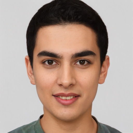 Joyful latino young-adult male with short  black hair and brown eyes