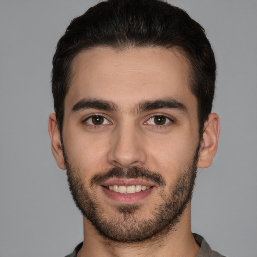 Joyful white young-adult male with short  brown hair and brown eyes