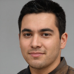 Joyful white young-adult male with short  black hair and brown eyes