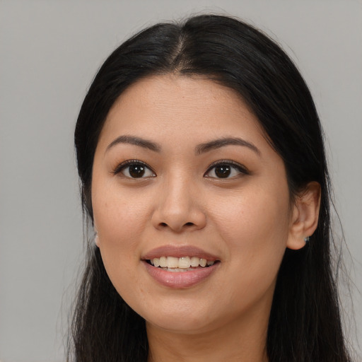 Joyful asian young-adult female with long  brown hair and brown eyes