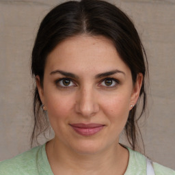 Joyful white young-adult female with medium  brown hair and brown eyes