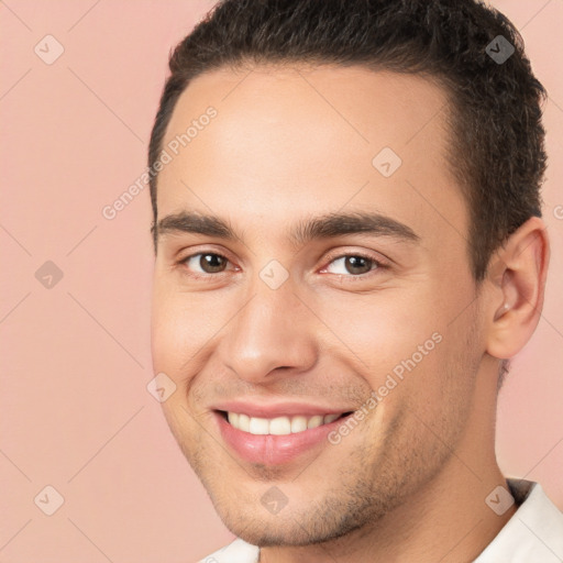 Joyful white young-adult male with short  brown hair and brown eyes