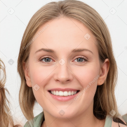 Joyful white young-adult female with medium  brown hair and blue eyes