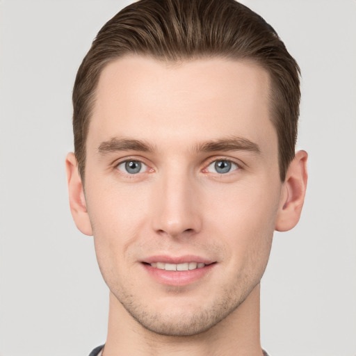 Joyful white young-adult male with short  brown hair and grey eyes