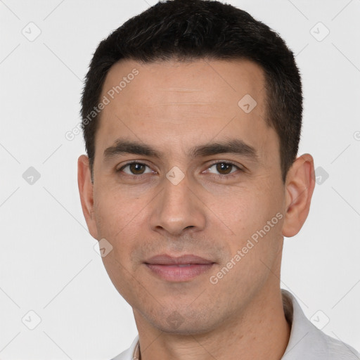 Joyful white young-adult male with short  black hair and brown eyes